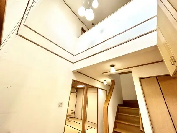 玄関上部は吹き抜けで開放的です。南側上部に設けられた窓から陽光が降り注ぎ、明るい雰囲気です。